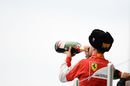 Sebastian Vettel celebrates on the podium with champagne