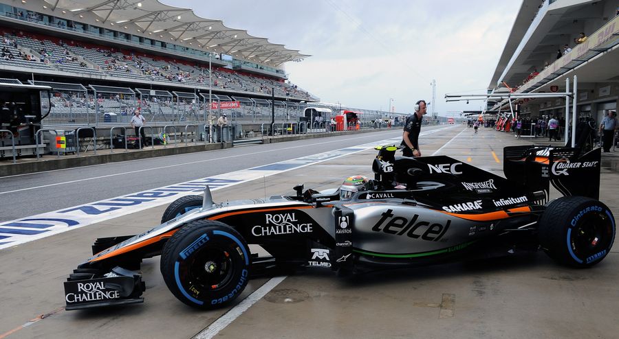 Sergio Perez leaves the garage on wet tyers
