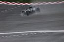 Nico Rosberg drives through the spray