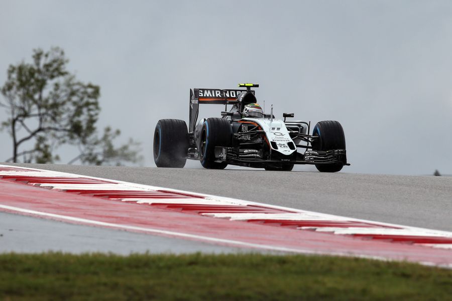 Sergio Perez runs through the wet track
