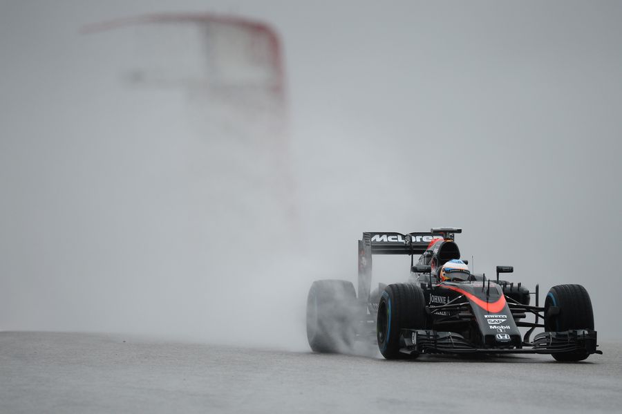 Fernando Alonso on track with a set of wet tyres