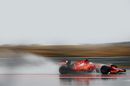 Sebastian Vettel drives through the spray