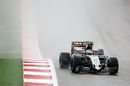 Sergio Perez drives through the spray