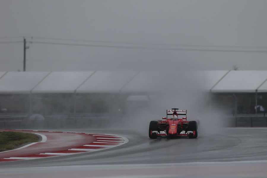 Sebastian Vettel drives through the spray