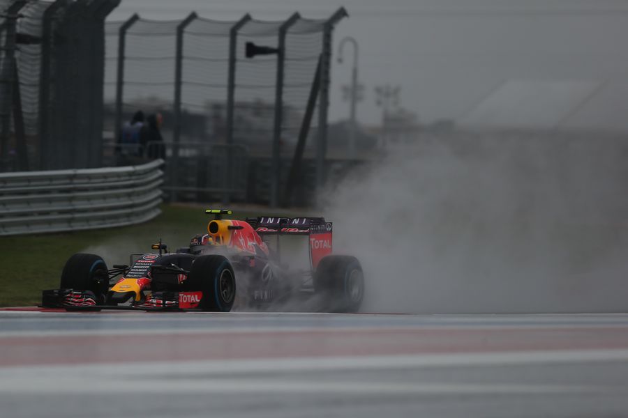 Daniil Kvyat speeds through the mist and rain