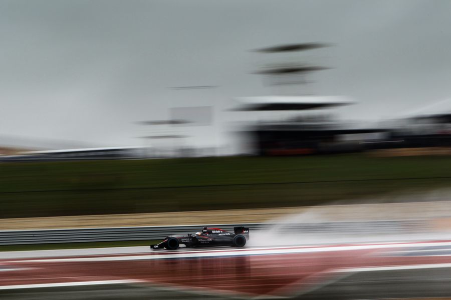 Fernando Alonso drives through the spray