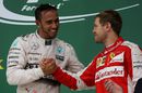 Sebastian Vettel celebrates Lewis Hamilton on the podium