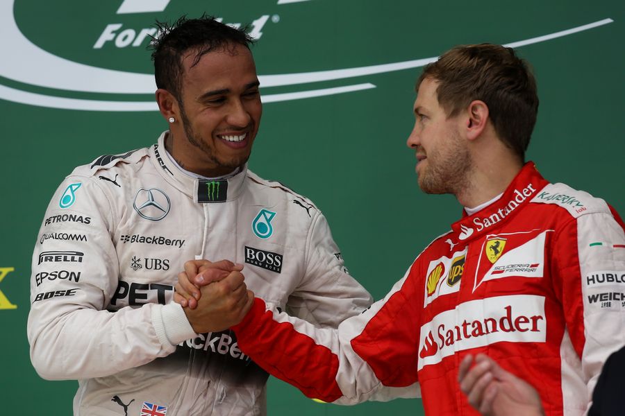 Sebastian Vettel celebrates Lewis Hamilton on the podium