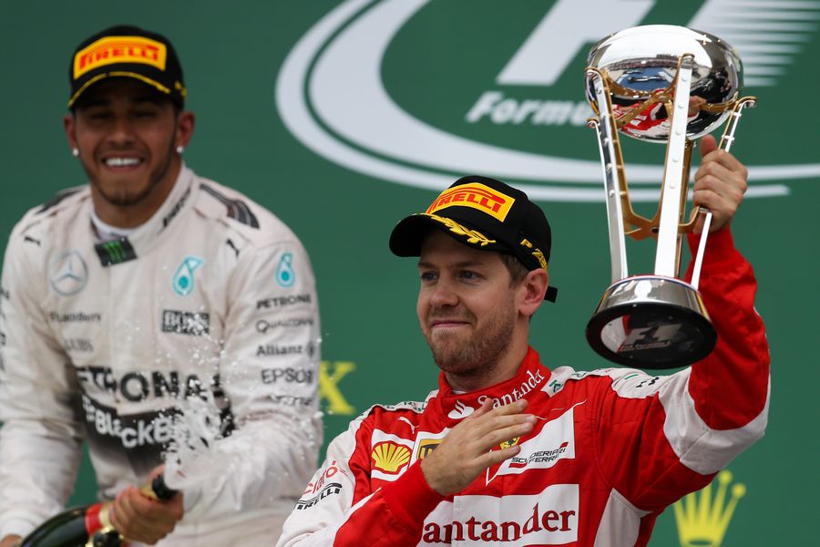 Sebastian Vettel celebrates with the trophy on the podium
