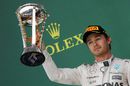 Nico Rosberg celebrates with the trophy on the podium