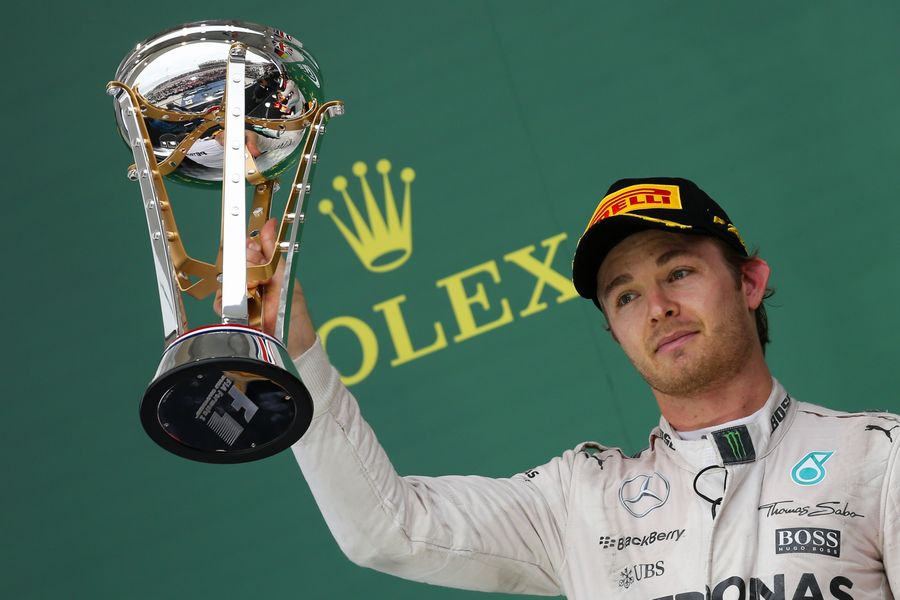 Nico Rosberg celebrates with the trophy on the podium