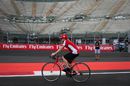 Kimi Raikkonen rides the circuit on a bike