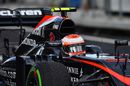 Jenson Button cranks on the steering lock in the McLaren