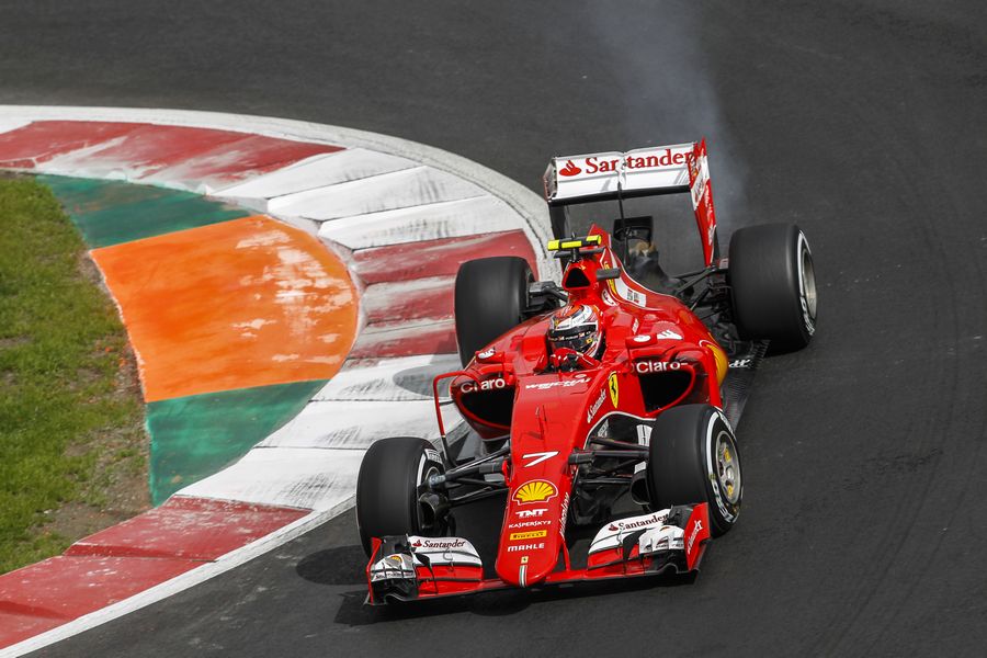 Smoke billows from the back of Kimi Raikkonen's Ferrari
