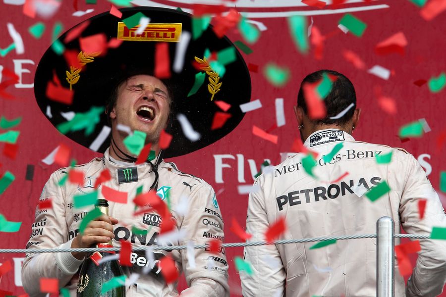 Nico Rosberg celebrates his win on the podium with champagne