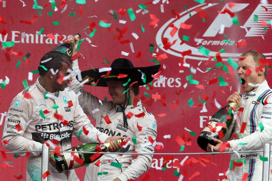 Top three drivers celebrate on the podium with champagne