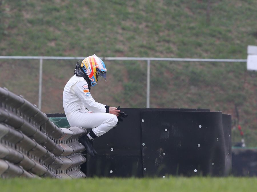 Fernando Alonso waits for the recovery truck after having another engine failure