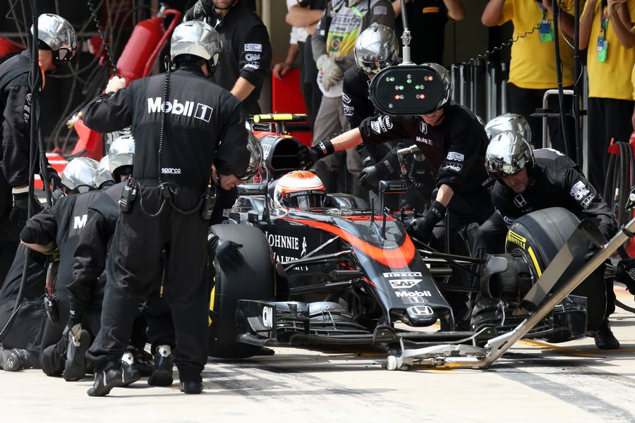 Jenson Button  makes the first pit stop during the race