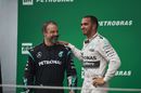 Lewis Hamilton celebrates on the podium with James Waddell