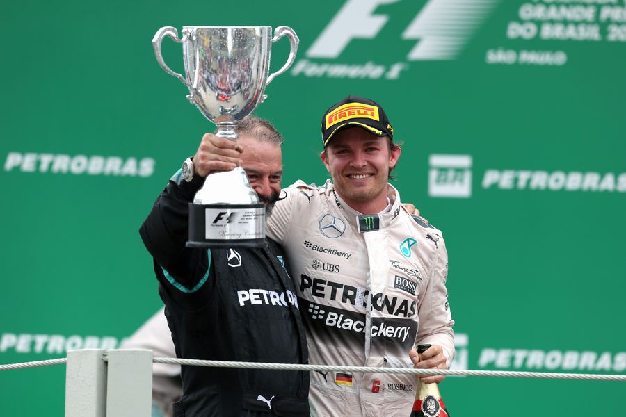 Nico Rosberg celebrates on the podium with James Waddell