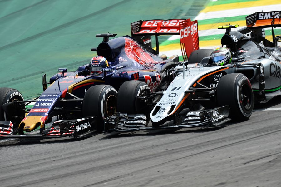 Max Verstappen battles for a position with Sergio Perez
