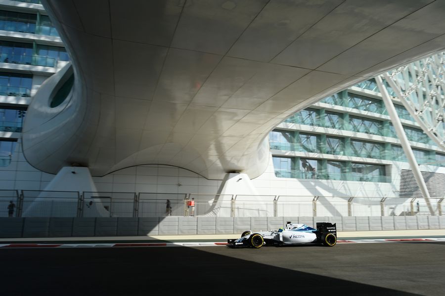 Felipe Massa passes underneath the Yas Hotel bridge