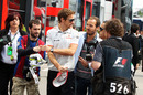 Jenson Button arrives at the circuit on race day