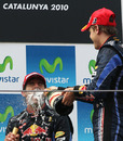 Sebastian Vettel sprays Mark Webber with champagne
