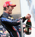 Mark Webber celebrates the spoils of victory