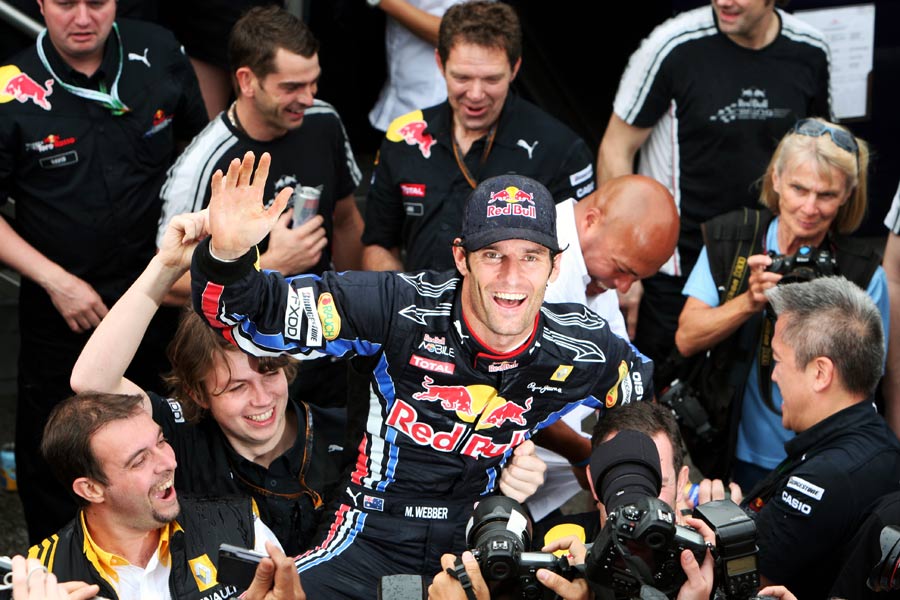 Mark Webber celebrates with his team