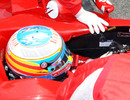 Ferrari's F-duct cockpit opening is visible under the mechanic's hand