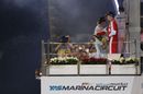 Kimi Raikkonen celebrates on the podium with champagne
