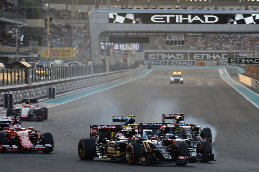 Pastor Maldonado fights for a position with Fernando Alonso at the start of the race