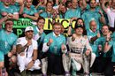 Nico Rosberg celebrates with Lewis Hamilton and Mercedes members