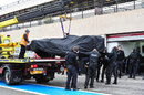 The McLaren is recovered after stopping on track