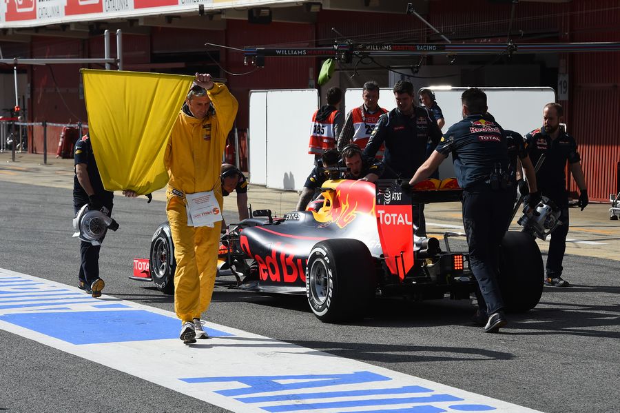 Daniil Kvyat in the RB12 is pushed back by the Red Bull mechanics