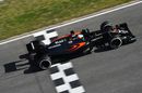 Fernando Alonso crosses the line in the McLaren MP4-31