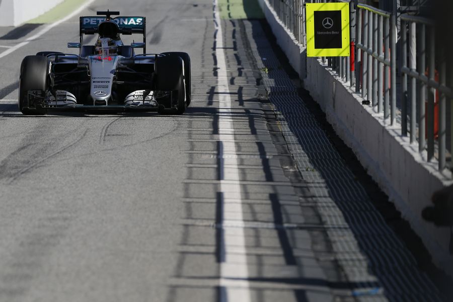 Lewis Hamilton makes his way down the pit lane