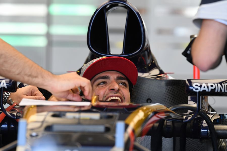 Carlos Sainz sits in the cockpit in a relaxed mood