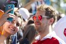 Sebastian Vettel poses for a selfie with the fans