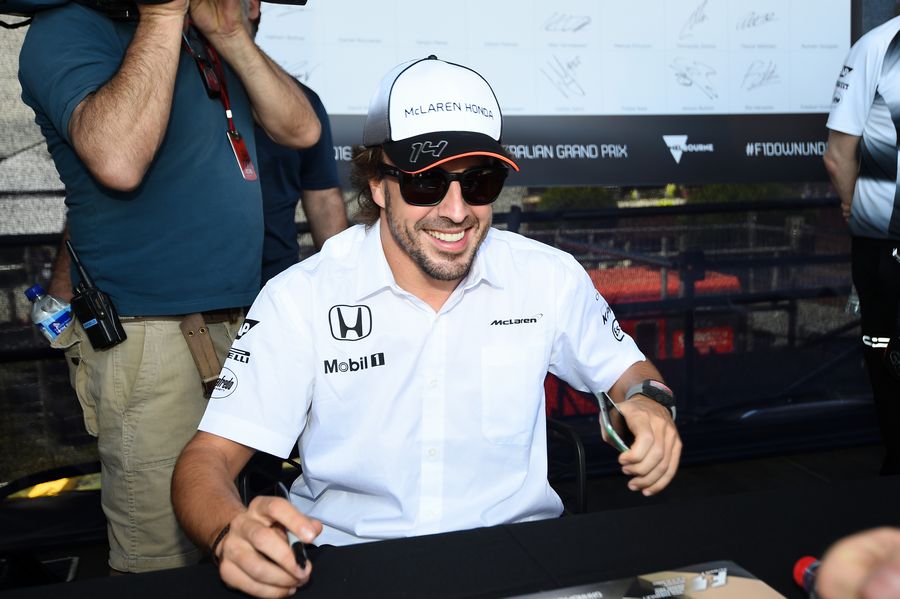 Fernando Alonso signs autographs for the fans
