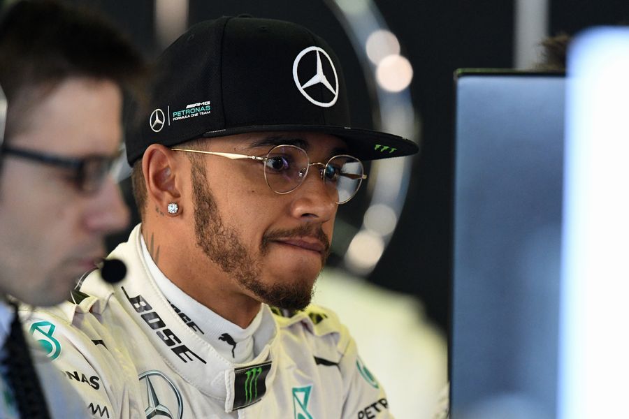 Lewis Hamilton with his eyes fixed on the monitor
