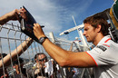 Jenson Button signs autographs for fans on Wednesday