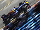 Mark Webber flashes past grandstands in the Red Bull