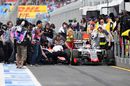 Mechanics work hard to pull away cars as Rio Haryanto and Romain Grosjean collide