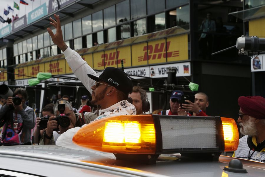 Pole sitter Lewis Hamilton waves to fans