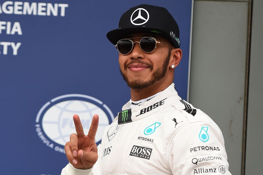 Lewis Hamilton celebrates for taking pole position