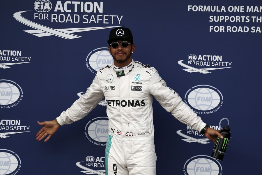 Lewis Hamilton celebrates his pole in parc ferme