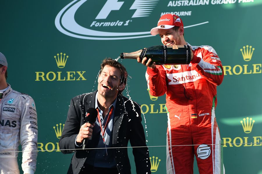 Sebastian Vettel pours champagne on Mark Webber