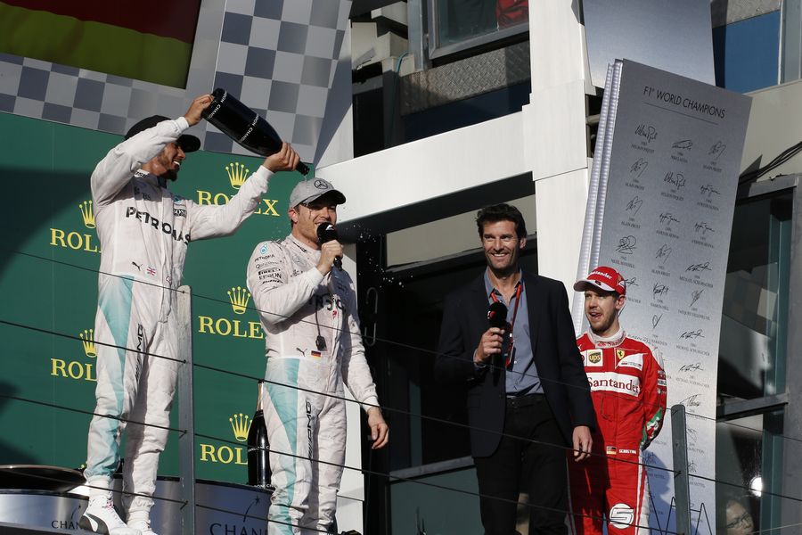 Lewis Hamilton pours champagne on Nico Rosberg